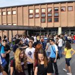 American Students CHARGED Triple While Illegals Skate A large group of students socializing outside a school building