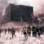 Emergency responders and civilians amidst debris at a disaster site