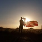 Shocking Death at ‘Trump House’ Ignites Controversy Silhouette of a person holding an American flag against a sunset