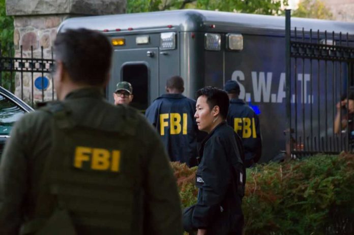 fbi358922228 FBI and SWAT team gathered near vehicle.