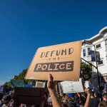 protesters holding signs at a street demonstration