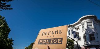 protesters holding signs at a street demonstration