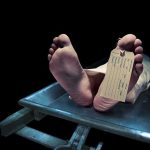 Family Exhumes Grave—Justice Denied Feet of a deceased person on a coroners table with an identification tag