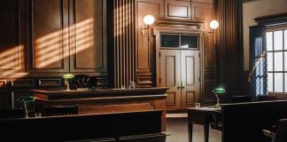 Empty courtroom with wooden benches and judge's bench