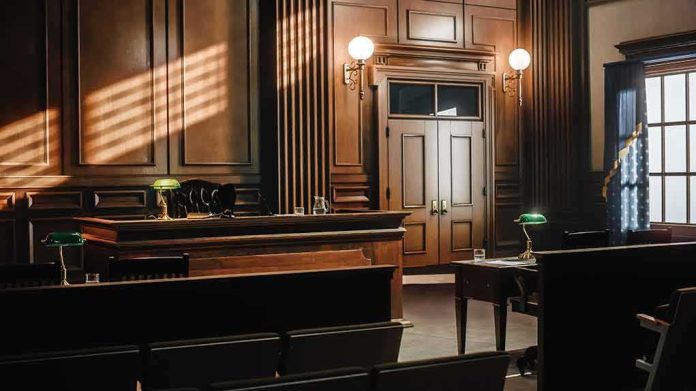 shutterstock_2056420760 Empty courtroom with wooden benches and judge's bench