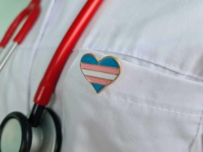 shutterstock_2269005799 Heart-shaped pin on a white lab coat with red stethoscope