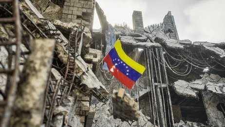 shutterstock_2654874977 Venezuelan flag among ruins of a collapsed concrete building