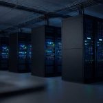 Rows of illuminated server racks in a dark data center