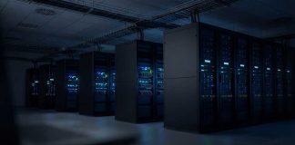 Rows of illuminated server racks in a dark data center