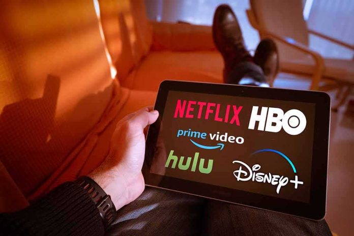 Person holding a tablet showing streaming service logos