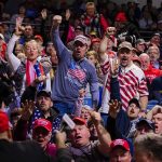 Russian Playbook Hits France—Again Crowd of supporters cheering at an indoor political rally