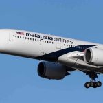 Malaysia Airlines jet on final approach with landing gear down