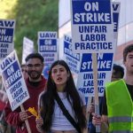 Federal Monitor Drops Hammer On UAW Leader Protesters marching with blue and white strike signs