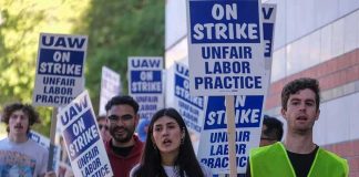 Protesters marching with blue and white strike signs
