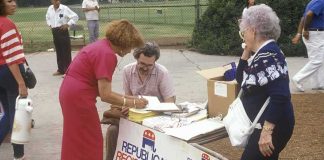 People at an outdoor voter registration table