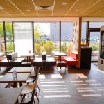 Fast-food restaurant interior with self-order kiosk and seating