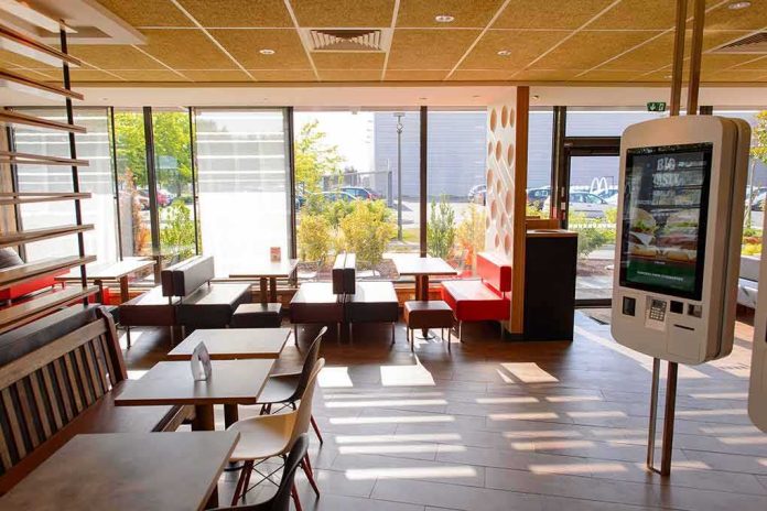 Fast-food restaurant interior with self-order kiosk and seating