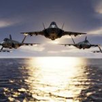 Missile Storm Forces Radical USAF Reboot Five jets flying low over the ocean at sunset.