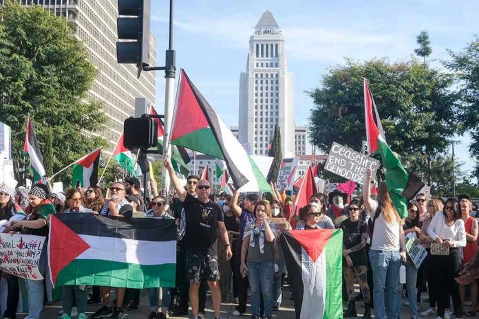 2384136043 Protesters holding Palestinian flags gather in a city street