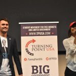 Two speakers on stage at a Turning Point USA event