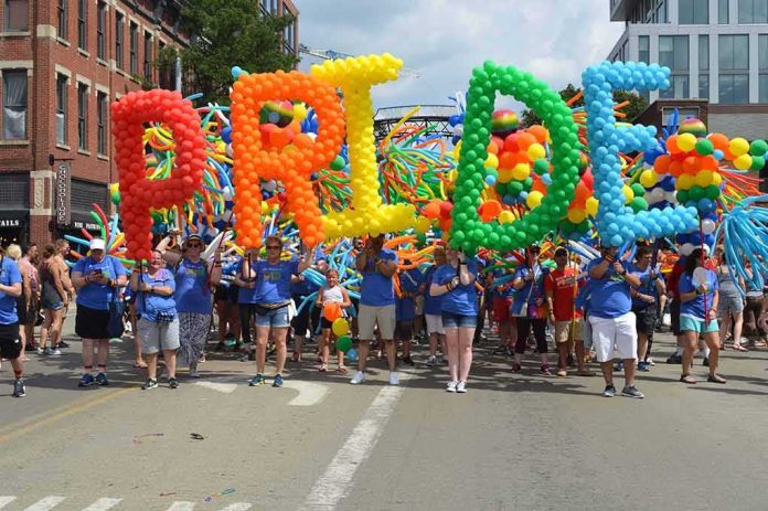 parade participants carry giant rainbow balloon letters spelling a word
