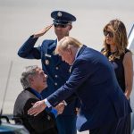 Donald Trump greets Greg Abbott as Melania Trump and Daryl Harper look on at an airport
