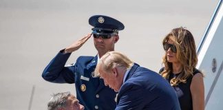 Donald Trump greets Greg Abbott as Melania Trump and Daryl Harper look on at an airport