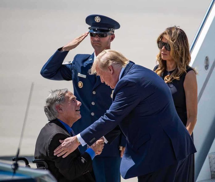 shutterstock_1473199076-1 Donald Trump greets Greg Abbott as Melania Trump and Daryl Harper look on at an airport
