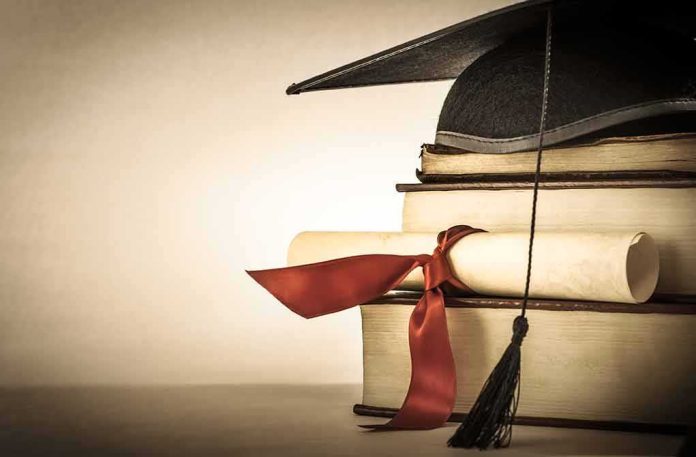 Graduation cap and diploma on stacked books