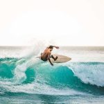 California’s Most Dangerous Beach Find Returns surfer carving on a turquoise wave at sunset