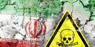 Iran flag on cracked wall with yellow skull and crossbones warning sign