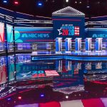 Projection Shock: Race Over In Minutes Televised debate stage with multiple podiums and bright red, white, and blue lighting