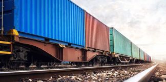 Freight train with colorful shipping containers on railway tracks
