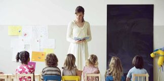 Teacher reading to children seated in a classroom