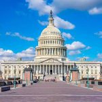 United States Capitol building under a bright blue sky