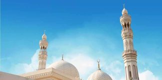 Mosque with domes and minarets against a clear blue sky