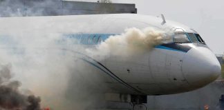 Airplane with smoke billowing from cockpit area
