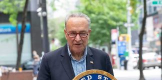 man speaking at a podium with a United States Senate seal