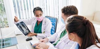 Doctors reviewing chest X-ray at a workstation