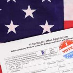 Passport Or No Ballot? Voter registration form with I Voted sticker on American flag