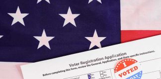 Voter registration form with I Voted sticker on American flag
