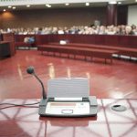 Fifth Amendment Firestorm Engulfs Fauci Conference microphone on a podium in a courtroom