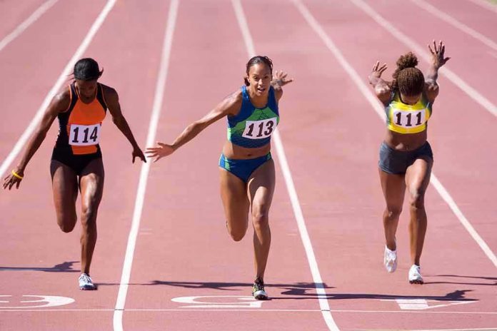 sprinters finish a race on an outdoor track