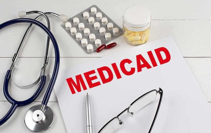 Medicaid document with stethoscope and medications on desk