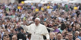 Francis waves from a vehicle amid a large crowd; Keith Allen and Andreas Hestler are also present