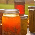 assorted canned goods in mason jars on a table
