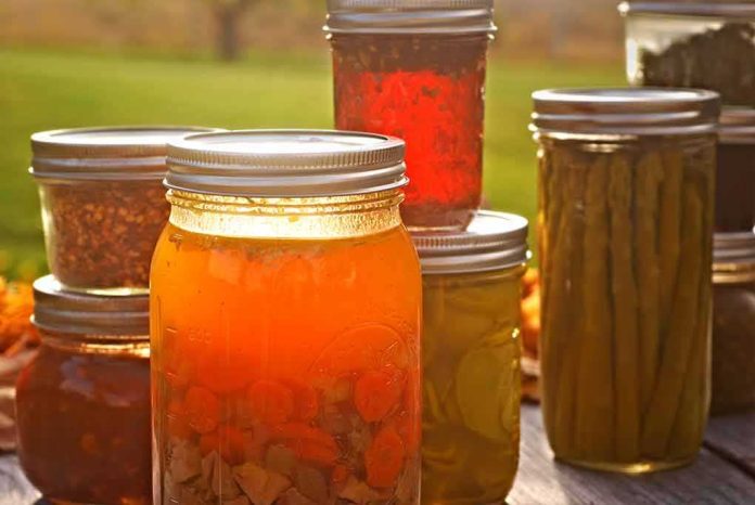 shutterstock_226700434 assorted canned goods in mason jars on a table