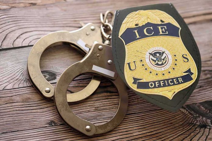 ICE officer badge and handcuffs on wooden surface