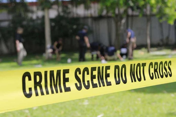 shutterstock_308657879 crime scene tape cordoning off a grassy area