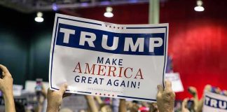 Crowd holding a political rally sign